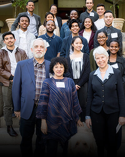 Group of professionals posing for a group photo together outside