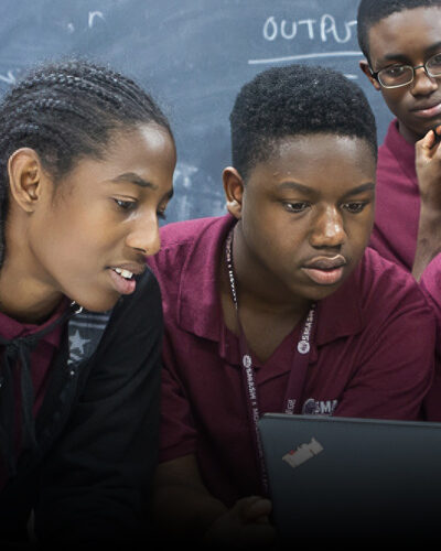 Group of students working on a laptop together